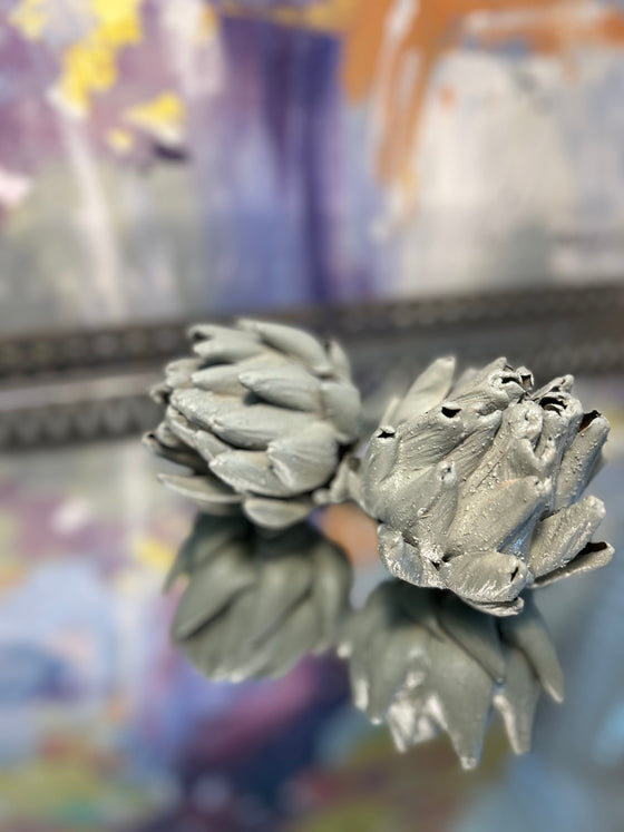 Artichoke buds that were dried and cast in a duck egg colour cement. 