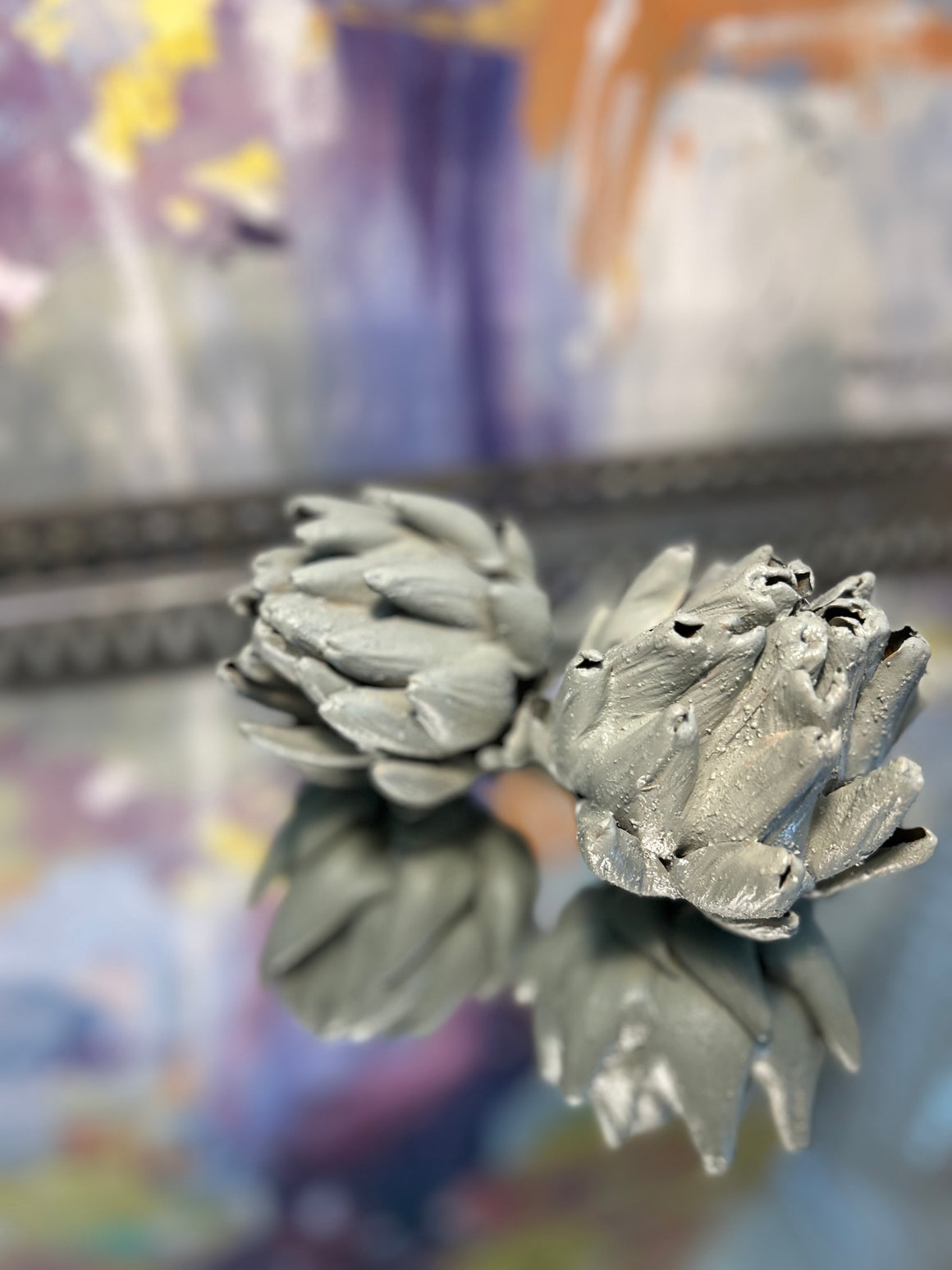 Artichoke buds that were dried and cast in a duck egg colour cement. 