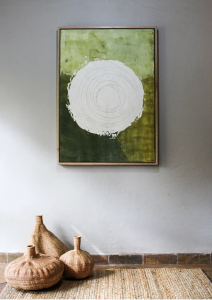 The green tones surrounding the circle symbolize the earth, grounding the work in nature’s quiet power. The texture and subtle cracks in the paint reflect time's passage, suggesting that even in stillness, there is movement and change