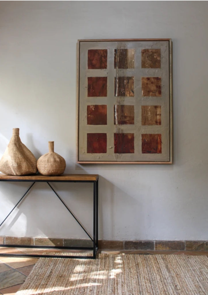 Room interior with a console table, decorative vases, and abstract wall art.